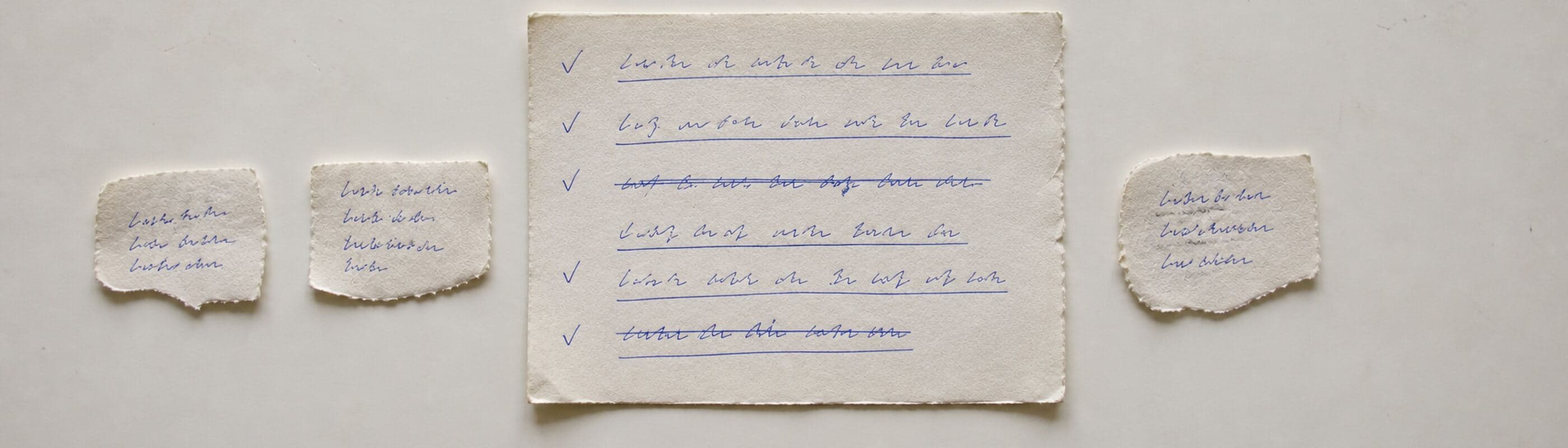 A handwritten page with several lines underlined in blue ballpoint, small ticks in the margin, and two lines struck through.